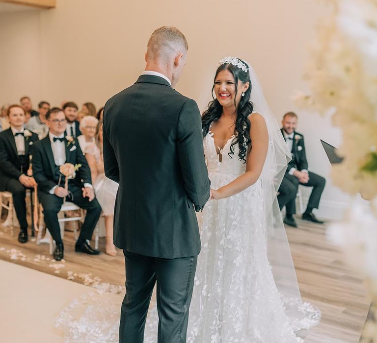 The bride and groom face each other for their bespoke wedding ceremony 