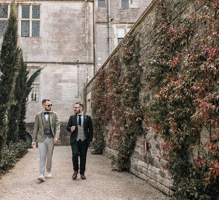 The two grooms walk around their traditional wedding venue together 