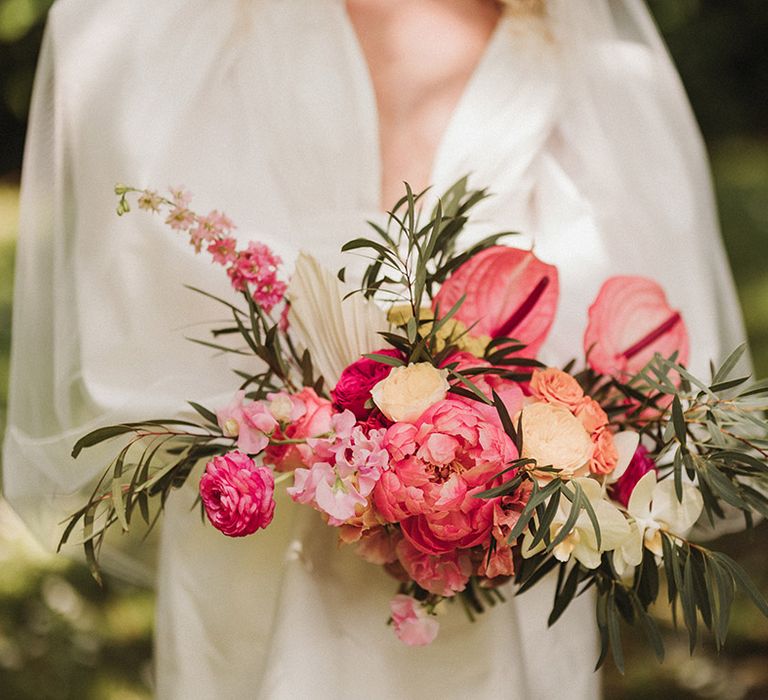 Pink oversized wedding bouquet with peonies, sweet pea, and anthuriums 