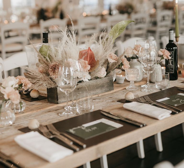 place setting with boho wedding flower arrangement in a wooden box 