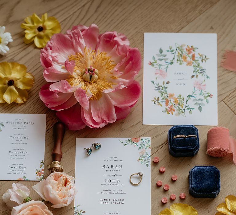 Flatlay of floral wedding stationery, wedding flowers, sparkly wedding shoes and wedding jewellery