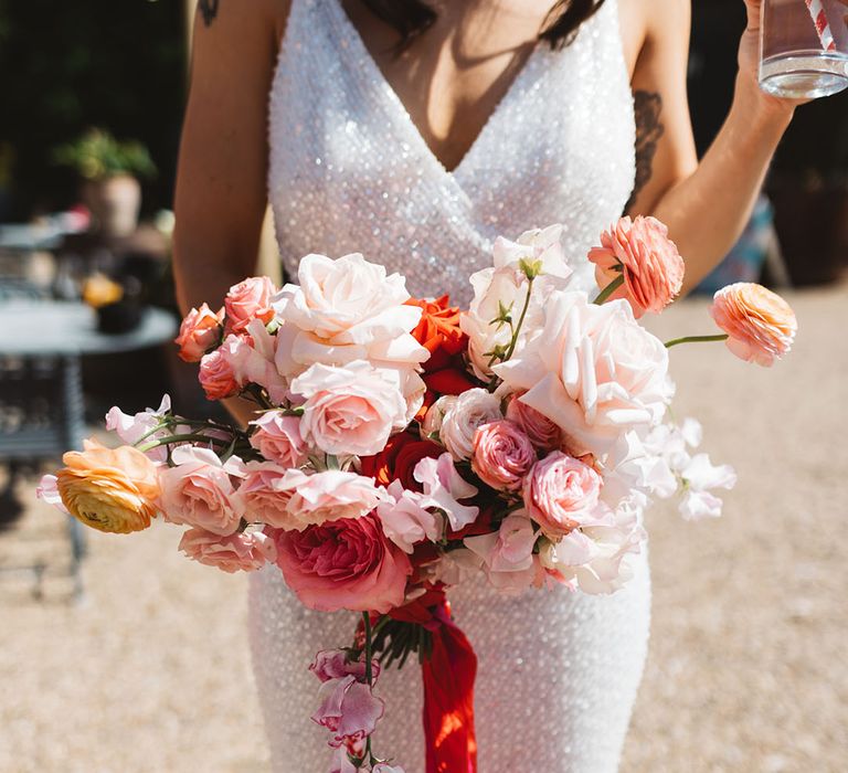 Pink roses with ranunculus and carnations tied with ribbon 