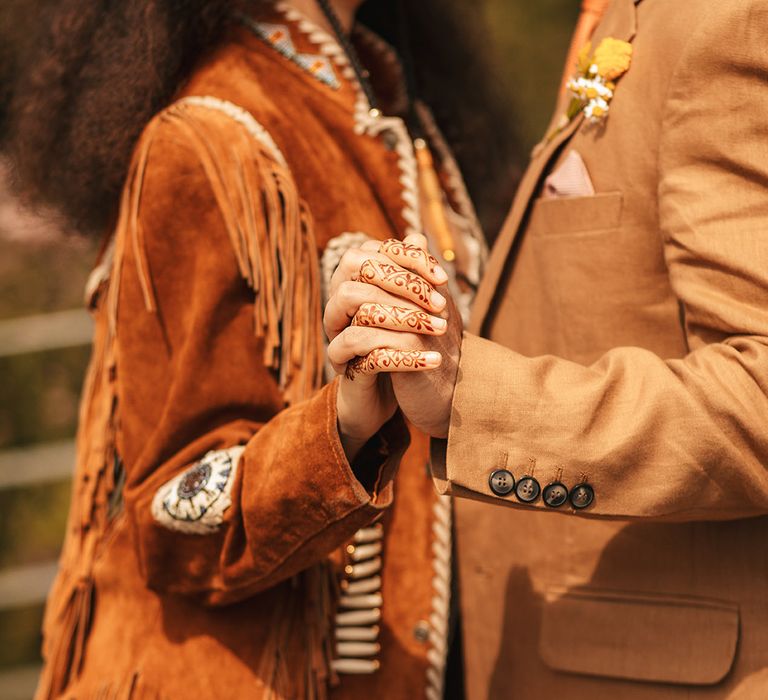 Woodstock wedding inspiration with the bride wearing a fringe jacket to match the Woodstock wedding theme 