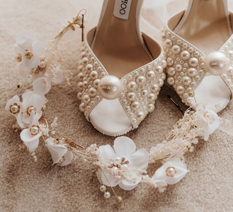 Delicate white floral and gold wedding headband with the pearl Jimmy Choo bridal shoes 