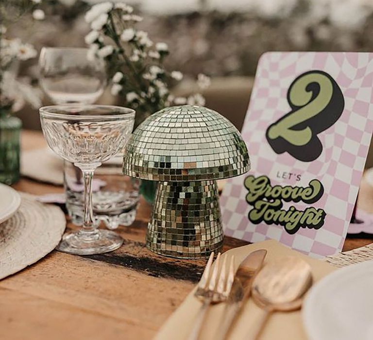 Mirrored mushroom shaped disco ball themed table decor at a wedding by Olegs & Rita Photography