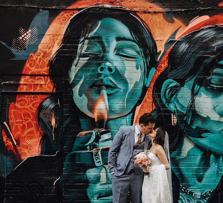 Urban mural painting in London used as backdrop for cute couple portrait 