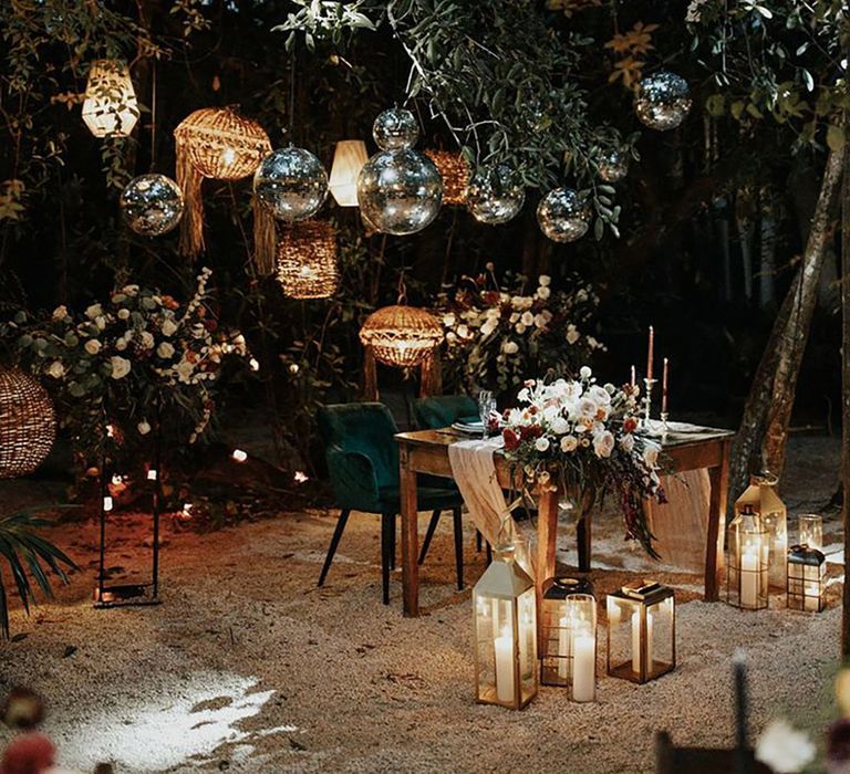 Mayan wedding ceremony with outdoor sweetheart table decorated with wooden lanterns and disco balls 