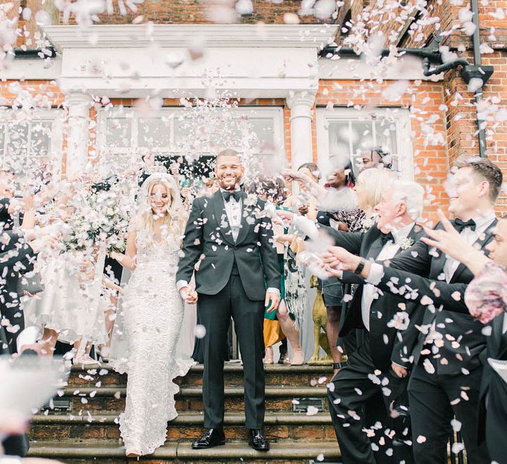 Bride and groom confetti moments at black tie winter wedding 