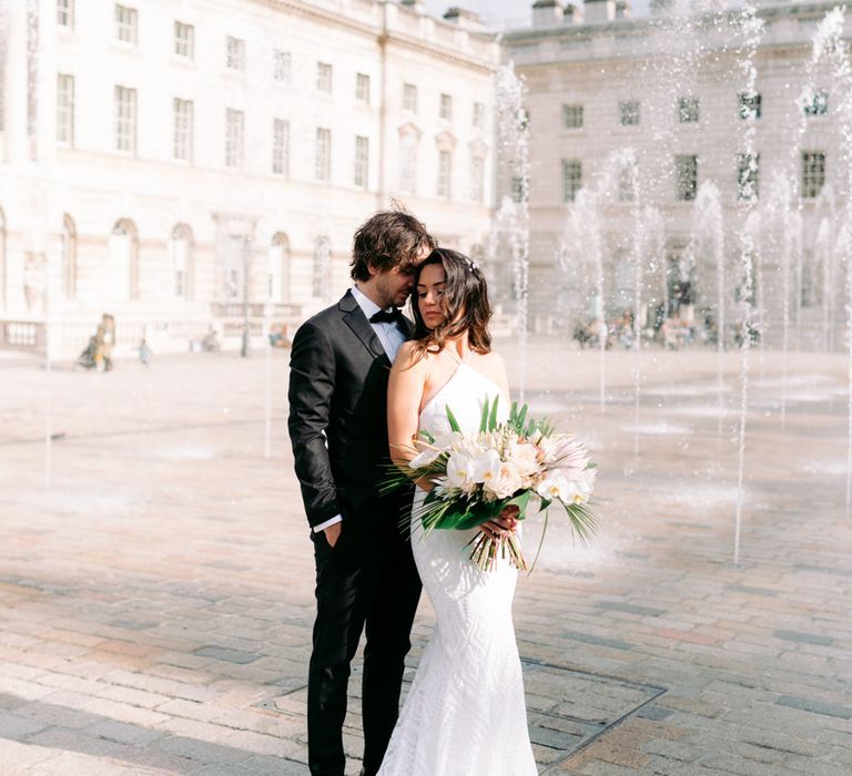 Bride and groom wedding photography by Somerset House water fountains 