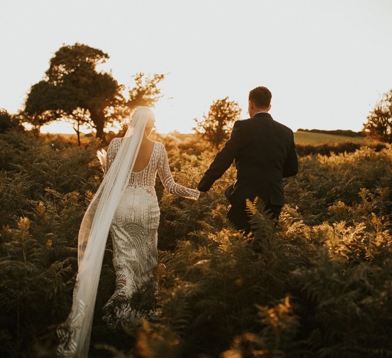 Bride in preloved wedding dress with cathedral length veil 