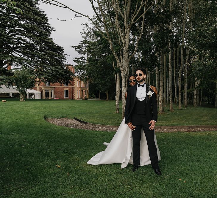 Groom in black tuxedo and sunglasses 