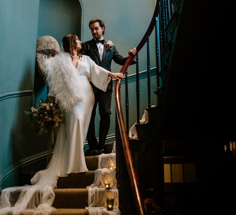 Dramatic staircase wedding day photography with bride wearing Marabou Fur stole