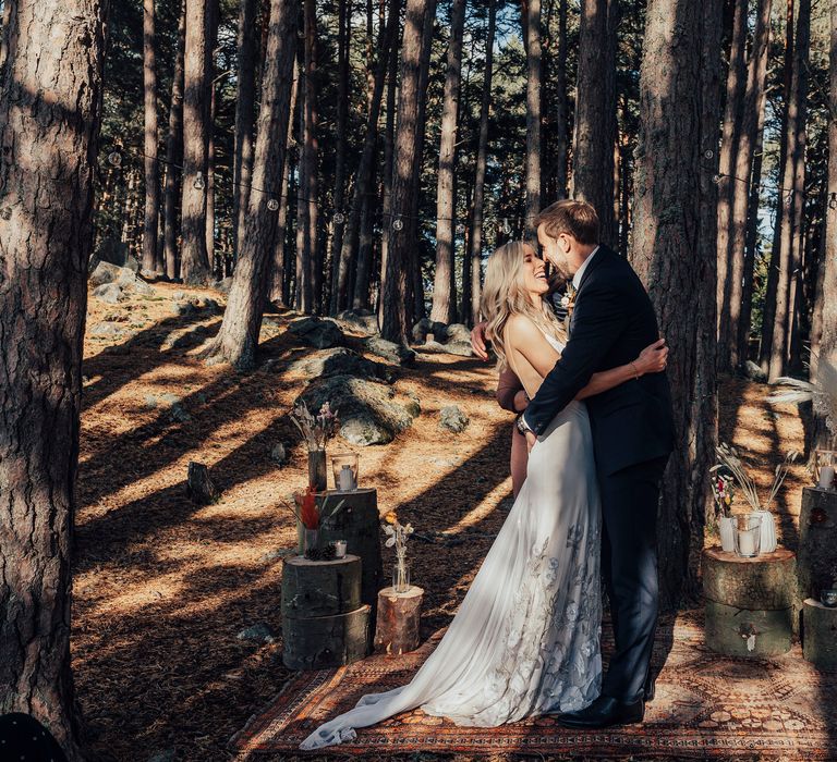 Bride & groom kiss in the woodland after wedding ceremony in Scotland