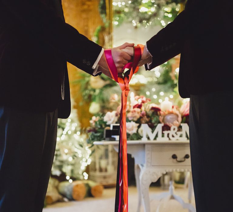 hand fasting ceremony with red ribbon 