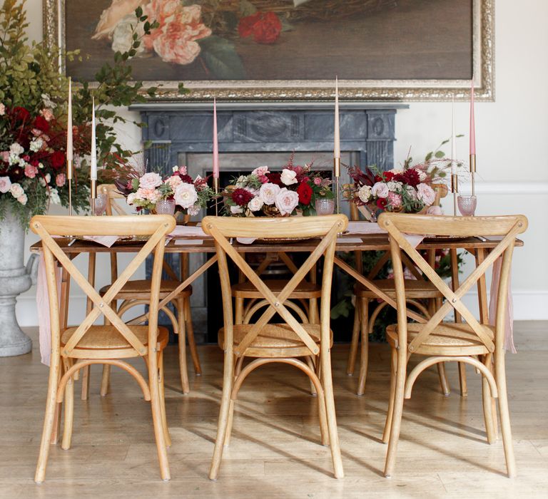 Wooden table featuring red floral decor