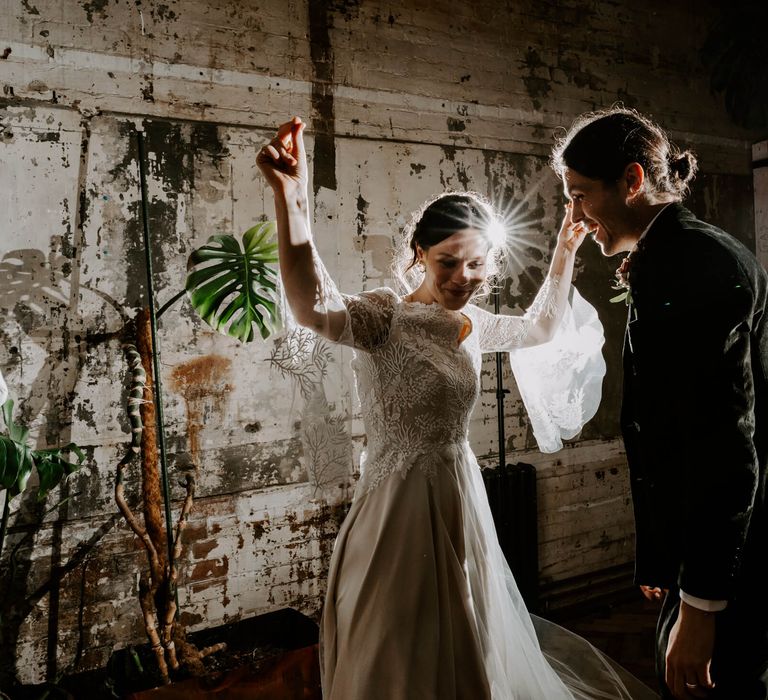 Bride and groom first dance in rustic wedding venue Clapton Court 