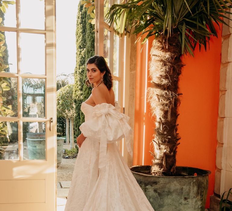 Bride wears full sleeved off the shoulder wedding gown with sweetheart neckline