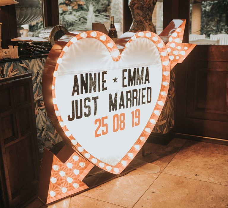 A heart shaped light box reads 'Annie and Emma Just Married 25.08.19'