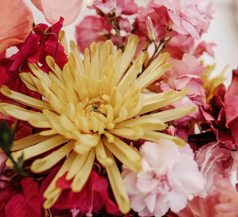 Yellow dahlia flower detail amongst pink floral bouquets for finca wedding in Spain