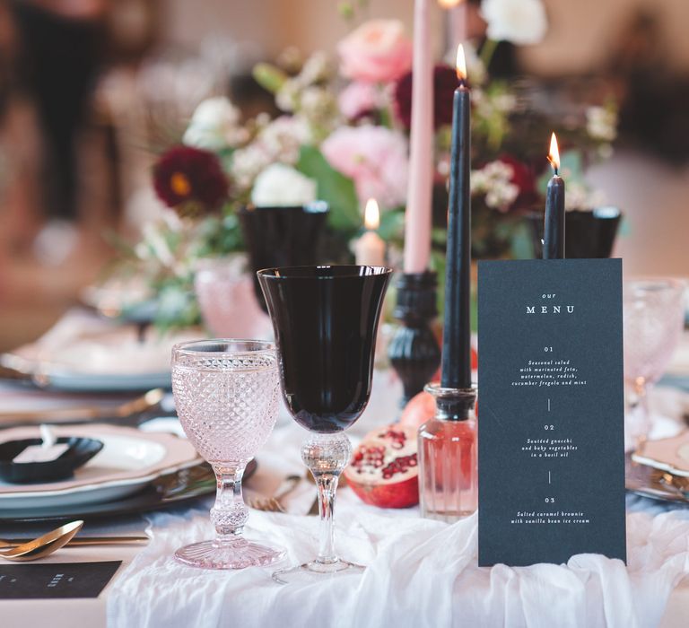 Black on the day wedding stationery menu card, taper candles and goblet table decor