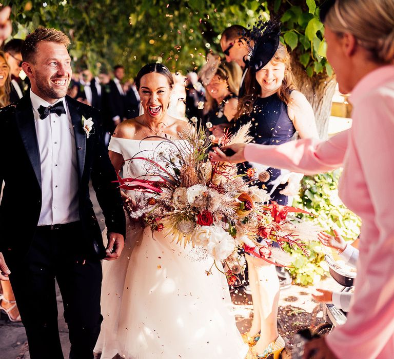 Confetti moment for bride and groom