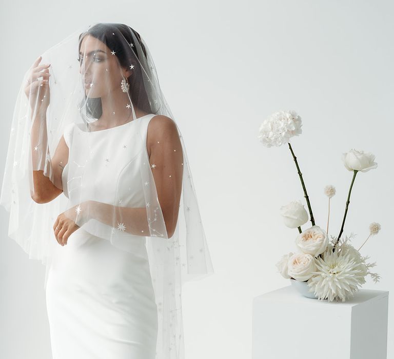 Minimalist wedding inspiration with bride in a fitted wedding dress with celestial drop veil by Rebecca Anne Designs