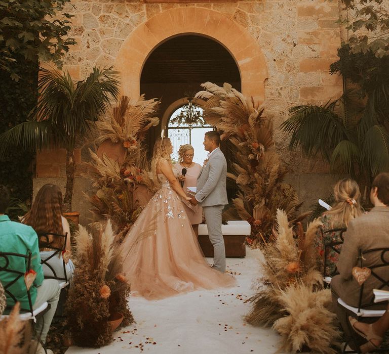 Bride & groom during outdoor wedding ceremony in Mallorca