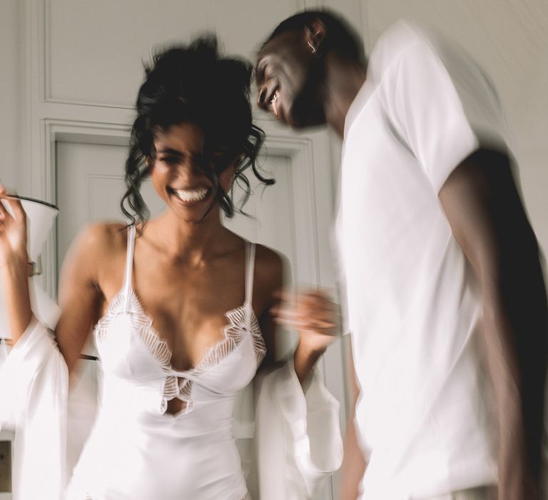 Bride and groom in the wedding morning in a white lace teddy and cotton t-shirt 