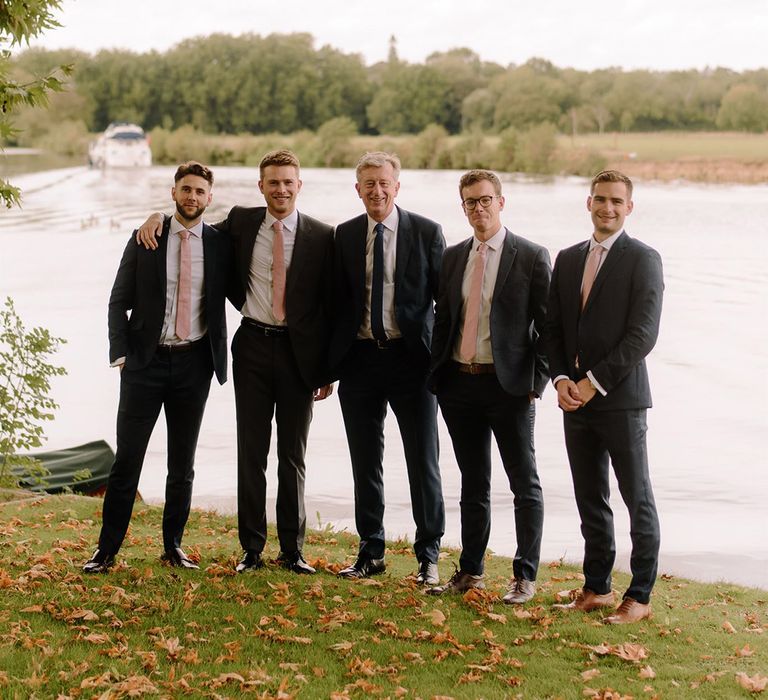 Groomsmen in matching pink ties