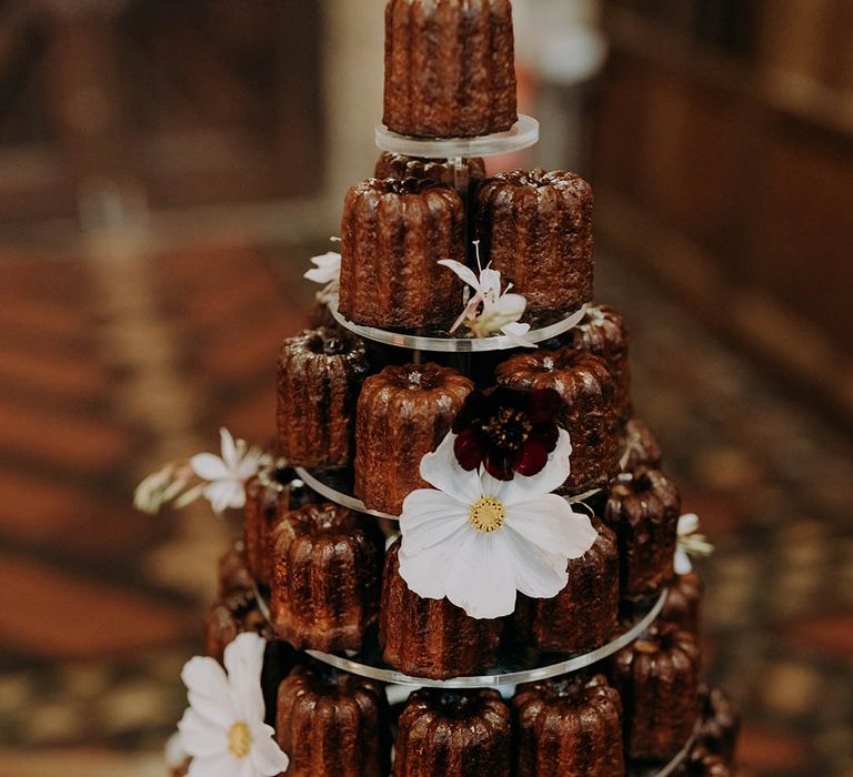 Mini bundt wedding cake on cake stand complete with floral decor 