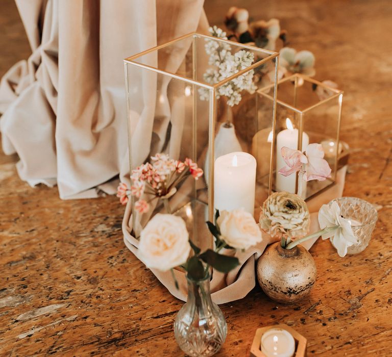 White pillar candles, pastel florals and draping for boho ceremony decor