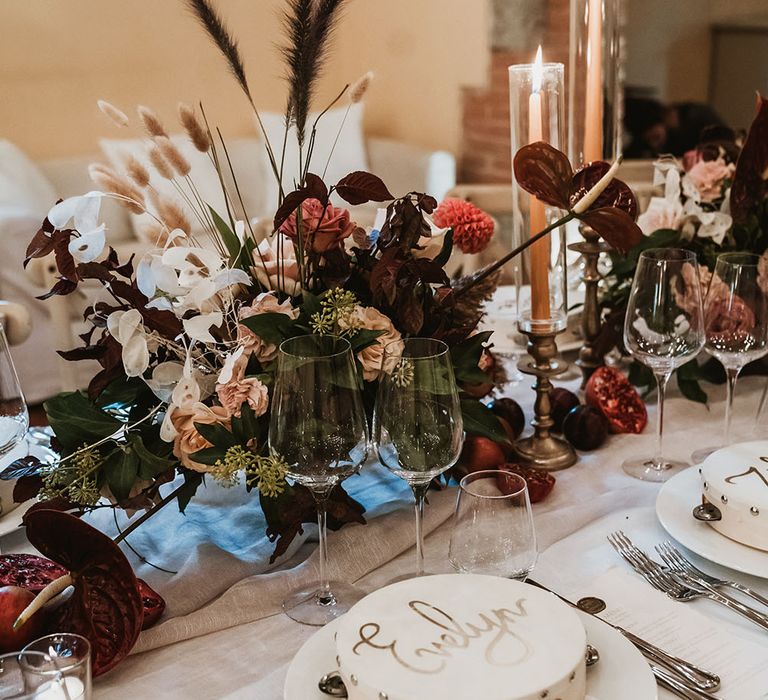 Personalised tambourine wedding favours on reception table complete with floral bouquets filled with Autumnal colours 