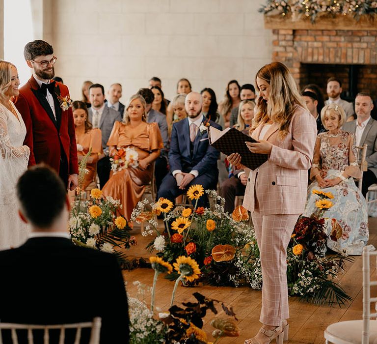 Bride and groom stand and hold hands for their humanist and handfasting wedding ceremony 