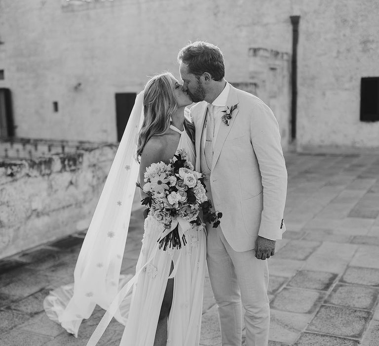 Bride and groom share a kiss for their Italian destination wedding 