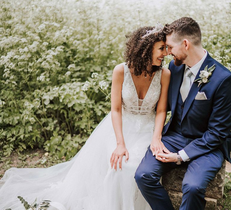 Bride looks lovingly toward her groom outdoors during couples portraits 