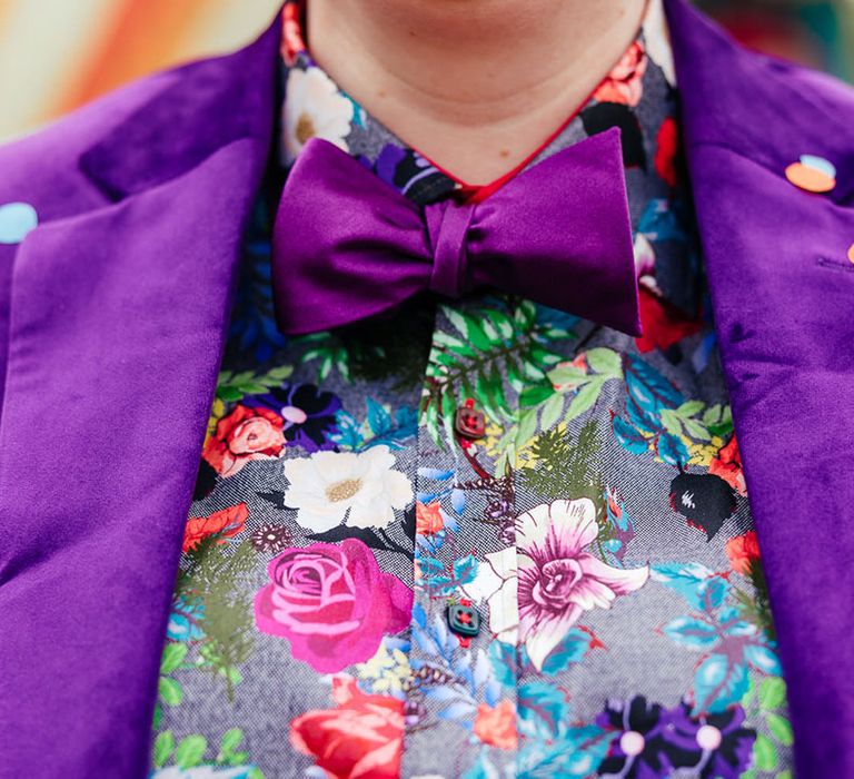 Bride in purple velvet blazer with purple bowtie, pink patterned pocket square and colourful patterned shirt 