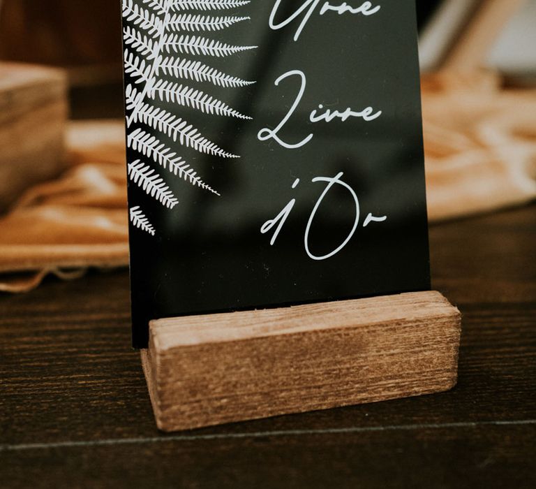 black acrylic wedding sign in a wooden plinth 