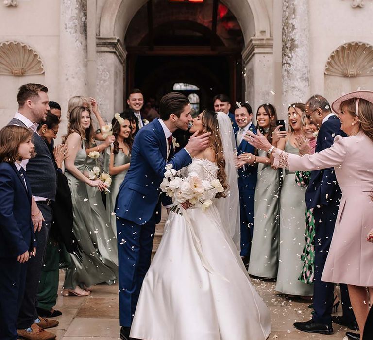 Luxury castle wedding venue with the bride and groom having their traditional confetti exit 