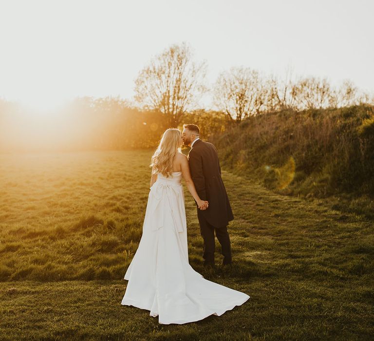 Golden hour wedding photography of the bride and groom at sunset 