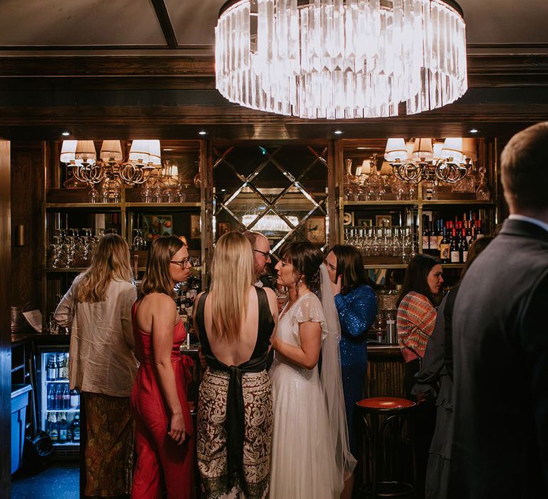 The Bedford in London wedding venue with guests standing at the bar ordering drinks 