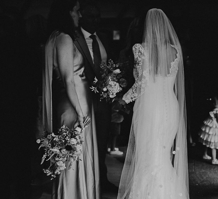 Bride in lace weding dress with bridesmaids in green satin dresses 