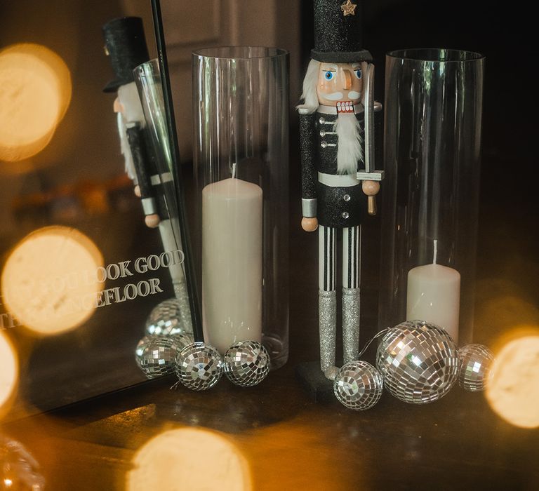 Winter wedding with Christmas wedding decor with black and white nutcracker, disco balls and candles 