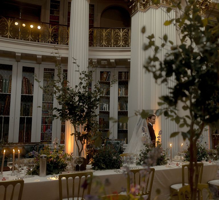 The bride and groom walk around their wedding breakfast at the Edinburgh wedding venue 