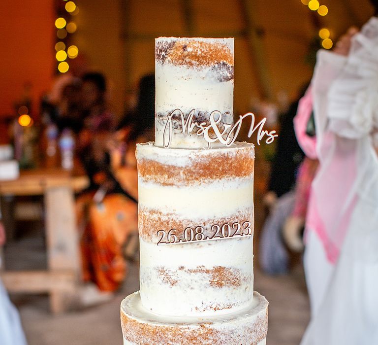 Semi naked rustic wedding cake with personalised wedding cake topper for festival tipi wedding 