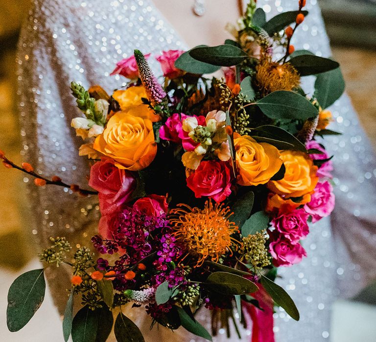 Bride in ASOS sequin wedding dress with pink and orange wedding bouquet 