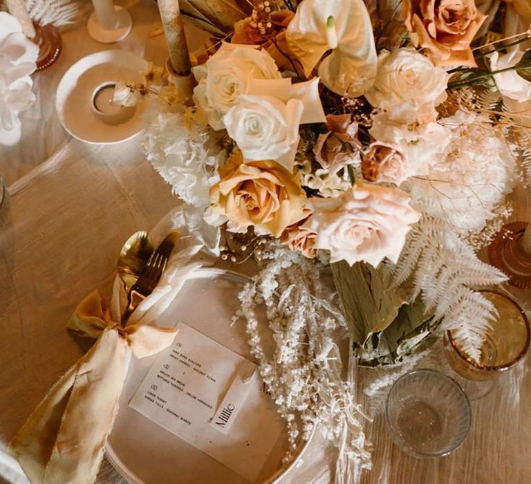 Beautiful Boho Wedding Place Setting With Candles and Blush and Neutral Flowers