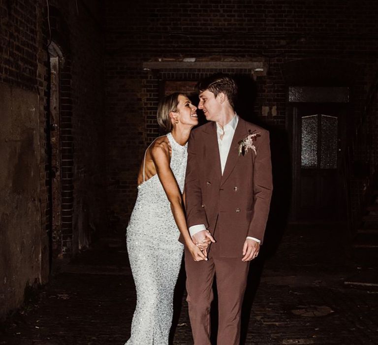 Bride in Sparkly Evening Dress with Groom in Brown Wedding Suit