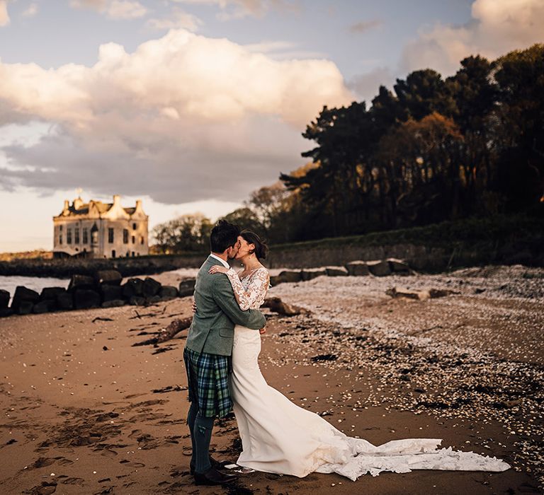 bride-and-groom-kissing-on-beach-at-scottish-castle-wedding