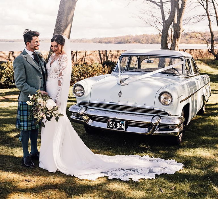 bride-and-groom-with-their-llight-blue-vintage-wedding-car