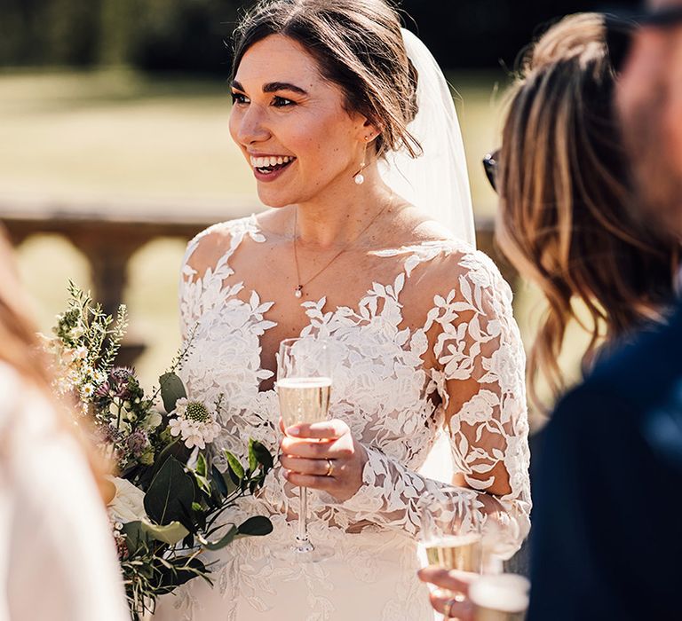 bride-wearing-long-sleeve-illusion-lace-wedding-dress